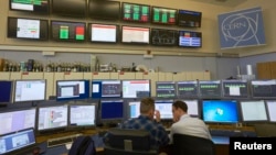 FILE - Technicians work in the Control Centre of the Large Hadron Collider (LHC) at the European Organisation for Nuclear Research (CERN) in Prevessin near Geneva, March 11, 2015. 