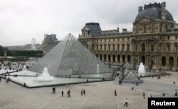 FILE - General view of the Louvre Museum in Paris, with the glass Pyramid entrance designed by Chinese-born U.S. architect I.M. Pei, Aug. 6, 2007.