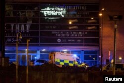 A police van and an ambulance are seen outside the Manchester Arena, where U.S. singer Ariana Grande had been performing, in Manchester, northern England, Britain May 22, 2017.
