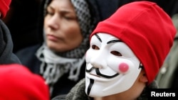 FILE - A protester wears a Guy Fawkes mask during a demonstration in Carhaix, western France, Nov. 30, 2013. 