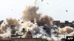 Smoke rises after a house is blown up during a military operation by Egyptian security forces in the Egyptian city of Rafah, near the border with southern Gaza Strip, Oct. 29, 2014.