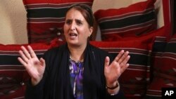 Taghreed Abu Teer, recalls being held by Hamas authorities for 11 days and interrogated under “humiliating circumstances” for her activities with the rival Fatah movement during an interview with The Associated Press at a relative's home in Khan Younis, southern Gaza Strip.