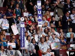 The Guam delegation is gathered as votes are cast during the second day of the Democratic National Convention in Philadelphia , July 26, 2016.