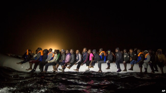 Refugees and migrants from many different African nationalities sit aboard an overcrowded rubber boat leaving Libyan territorial waters early March 5, 2017. A similar boat carrying more than 100 people sank off the coast of Libya earlier this week and dozens of people are missing.