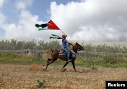 A man rides a horse during a rally of Israeli Arabs calling for the right of return for refugees who fled their homes during the 1948 Arab-Israeli War, near Atlit, Israel, April 19, 2018.