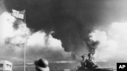 American ships burn during the Japanese attack on Pearl Harbor, Hawaii on Dec. 7, 1942.