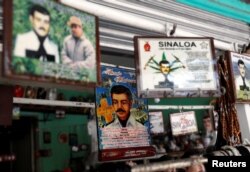 FILE - Souvenirs of "Malverde" are pictured in a store beside the "Saint Jesus Malverde" chapel in Culiacan, in Mexico's state of Sinaloa, Sept. 9, 2018.