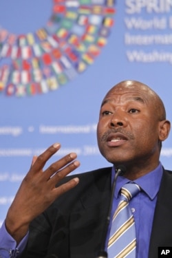 FILE - Lesetja Kganyago, who at the time was director general of South Africa's National Treasury, gestures during a news conference to discuss the G-24 meeting, April 14, 2011, at the 2011 spring meetings of the World Bank-IMF in Washington. He is now governor of the South African Reserve Bank.