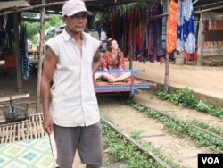 Ngul Nguon, 56, has been the bamboo train driver for almost 20 years. He earns the income from this tourism site. (Sun Narin/VOA Khmer)