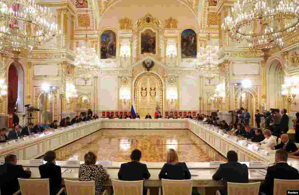 Members of the Presidential Council for Civil Society and Human Rights attend a meeting, chaired by Russian President Vladimir Putin, at St. Alexander's Hall of the Kremlin in Moscow, Russia, Oct. 1, 2015. 