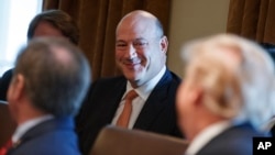 President Donald Trump speaks to outgoing White House chief economic adviser Gary Cohn during a cabinet meeting at the White House in Washington, March 8, 2018.