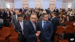 Members of Jehovah's Witnesses wait in a court room in Moscow, Russia, on April 20, 2017. Russia's Supreme Court has banned the Jehovah's Witnesses from operating in the country, accepting a request from the justice ministry.