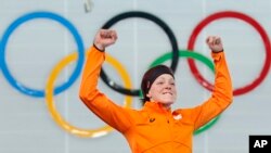 Gold medalist Jorien ter Mors of the Netherlands jumps in celebration during the flower ceremony for the women's 1,500-meter speedskating race at the Adler Arena Skating Center during the 2014 Winter Olympics in Sochi, Russia, Sunday, Feb. 16, 2014.