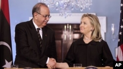 Secretary of State Hillary Clinton shakes hands with Libya's Prime Minister Abdurrahim el-Keib, March 8, 2012, at the State Department in Washington