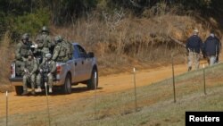 Law enforcement officials including the FBI at the scene of a shooting and hostage taking near Midland City, Alabama February 1, 2013. 