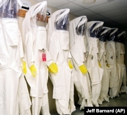 Protective suits hang ready to be donned June 8, 2004, by workers handling deadly nerve agents inside the Umatilla Chemical Agent Disposal Facility outside Hermiston, Ore., completed in 2001.