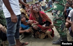 Rohingya refugees wait to receive aid in Cox's Bazar, Bangladesh, Sept. 27, 2017.