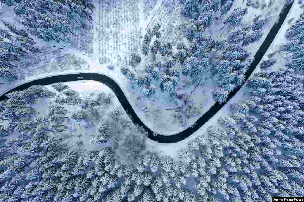 An aerial view shows a snow-covered landscape on a sunny winter day near Winterberg, western Germany.