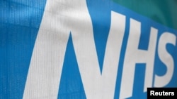 An NHS logo is displayed outside a hospital in London, Britain, May 14, 2017. 