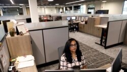 Shobha Surya, an employee at Ajinomoto, works in a shared office space in Itasca, Ill., Monday, June 7, 2021. Surya said she feels energized by the light pouring in from skylights at the new headquarters. She added that she missed her colleagues and is happy to be back in-person. (AP Photo/Shafkat Anowar)