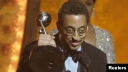 FILE - Actor and tap dancer Gregory Hines accepts the award for outstanding actor in a television movie, mini-series or dramatic special for "Bojangles," at the 33rd annual NAACP Image Awards, Los Angeles, CA, Feb. 23, 2002. 