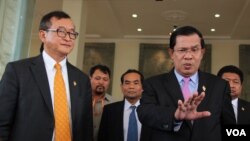 FILE - In this April 9, 2015, Cambodian Prime Minister Hun Sen (R) talks to the press with Sam Rainsy (L) president of the Cambodia National Rescue Party (CNRP), after the National Assembly vote to select the members of National Election Committee in Phnom Penh, Cambodia. 