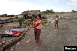 A local fisherman's family walks near a village at Made island outside Kyauk Pyu, Myanmar, May 17, 2017.