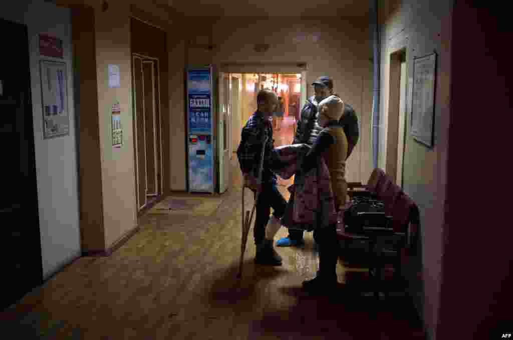 People visit their relatives at an emergency hospital after the shelling in Mariupol, Ukraine, Jan. 26, 2015.