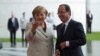 German Chancellor Angela Merkel welcomes French President Francois Hollande at the chancellery in Berlin, Germany, May 15, 2012. 