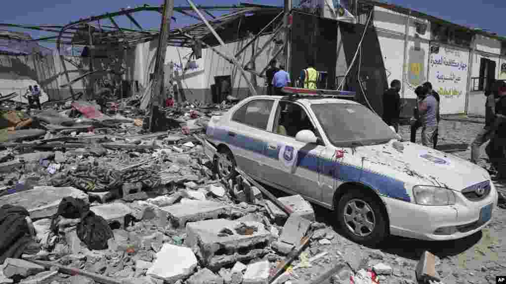 Debris covers the ground and an emergency vehicle after an airstrike at a detention center in Tajoura, east of Tripoli in Libya. An airstrike hit the detention center for migrants, killing several.