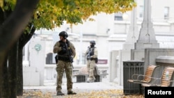 Police officers stand guard near the National War Memorial in downtown Ottawa October 23, 2014. 