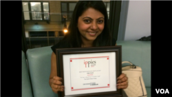 Jinal Shah of the South Asian Times proudly poses with her Ippies Award in New York, June 6, 2014. (A. Phillips/VOA)