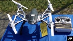 FILE - An Aug. 2015 photo of Yuneec Typhoon drone and controller in Jessup, Maryland, where State Police and prison officials say two men planned to use the drone to smuggle drugs, tobacco and pornography videos into the maximum-security Western Correctional Institution near Cumberland, Md. Illinois has yet to see a case where drones have been used to illegally smuggle items into correctional facilities, according to state officials. 