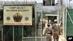 FILE - U.S. military guards enter the Camp Delta military-run prison at the Guantanamo Bay U.S. Naval Base, Cuba. 