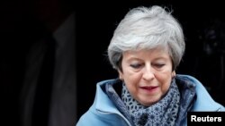 FILE - Britain's Prime Minister Theresa May leaves 10 Downing Street, as she faces a vote on alternative Brexit options, in London, Britain, March 27, 2019.