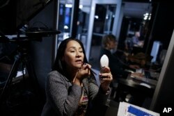 Former rebel Marilu Ramirez applies make up as she prepares to hosts an online television round table discussion at a studio in Bogota, Colombia, Nov. 14, 2017.