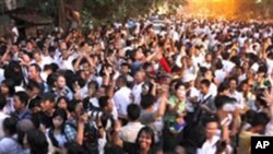 Supporters of Burma's pro-democracy leader Aung San Suu Kyi celebrate outside her home after her release from house arrest in Rangoon, 13 Nov 2010.