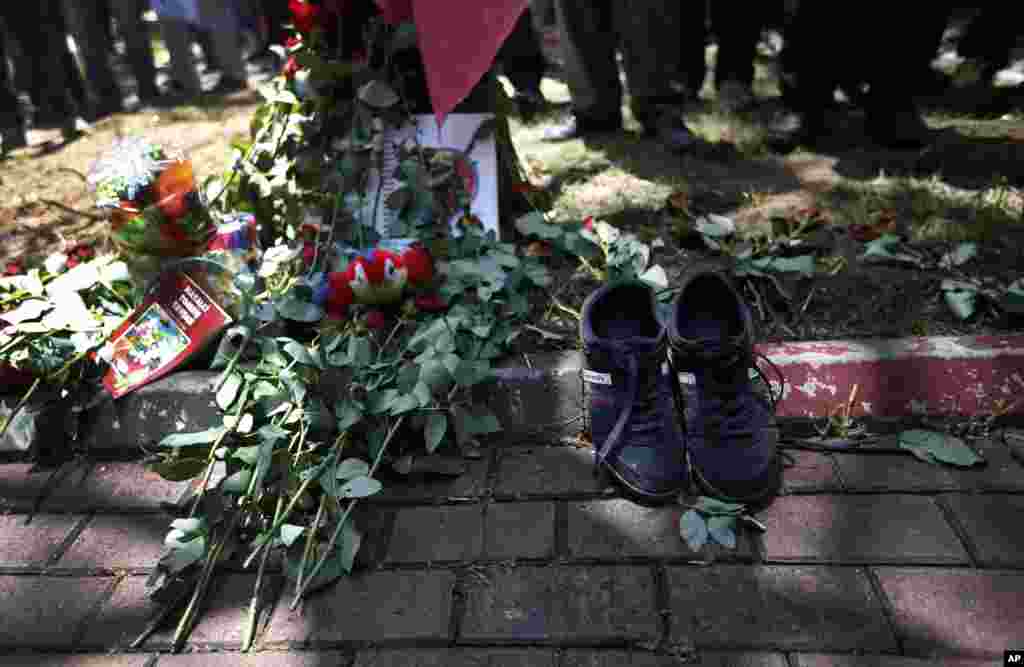 A pair of shoes belonging to a victim are seen next to flowers laid down by mourners at the site of Monday&#39;s explosion in the Turkish town of Suruc near the Syrian border, July 21, 2015.