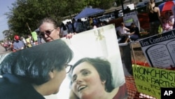 A supporter holds a large photo of Terri Schiavo in Pinellas Park, Fla. in 2005
