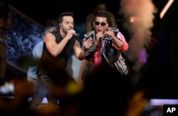 Singers Luis Fonsi, left and Daddy Yankee perform during the Latin Billboard Awards, April 27, 2017, in Coral Gables, Florida.