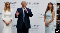 Republican presidential candidate Donald Trump, accompanied by, from left, Ivanka Trump and Melania Trump, speaks during grand opening of Trump International Hotel-Old Post Office, Oct. 26, 2016, in Washington.