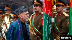 Afghanistan's President Hamid Karzai arrives at the opening ceremony of the fourth year of the Afghanistan parliament in Kabul, March 15, 2014. 