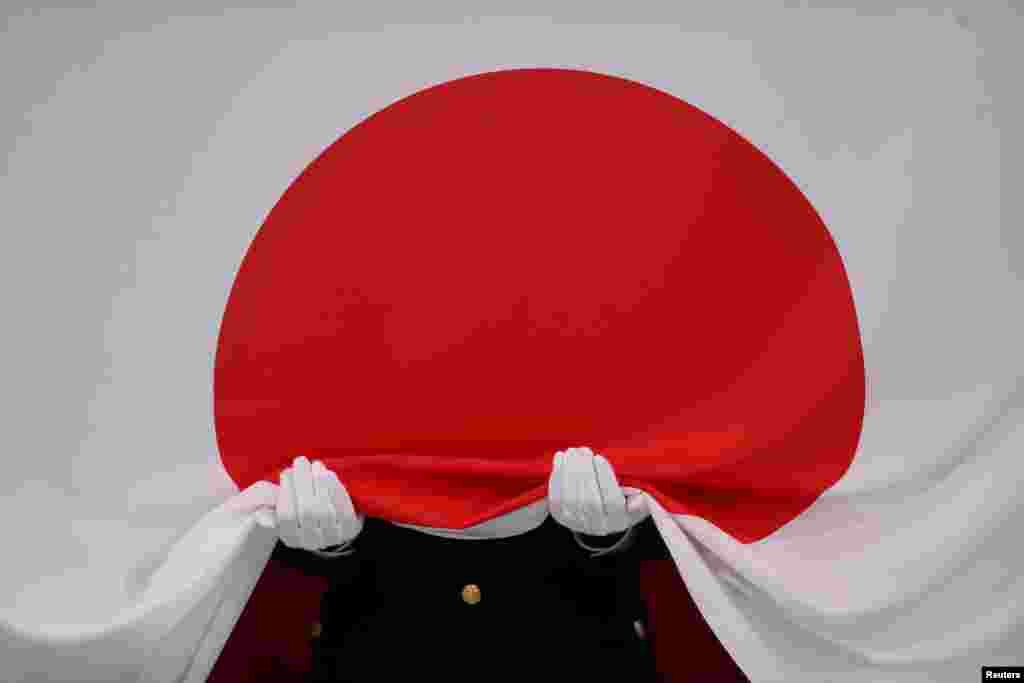 The Japanese national flag is seen before it flies at a medal ceremony dring the 2020 Olympics in Tokyo, Japan.
