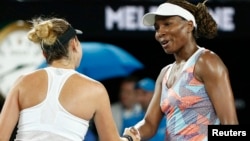 Tennis - Australian Open - Venus Williams of the U.S. v Belinda Bencic of Switzerland - Rod Laver Arena, Melbourne, Australia, January 15, 2018. Bencic and Williams shake hands after Bencic won their match. REUTERS/Thomas Peter.