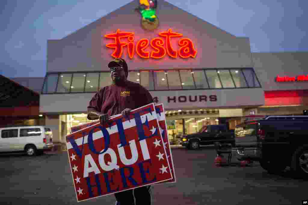 Volunteer election clerk Allie Green Jr. searches for places to post voting signs outside of a Fiesta Mart supermarket, a polling location, before polls open in Austin, Texas, March 1, 2016.