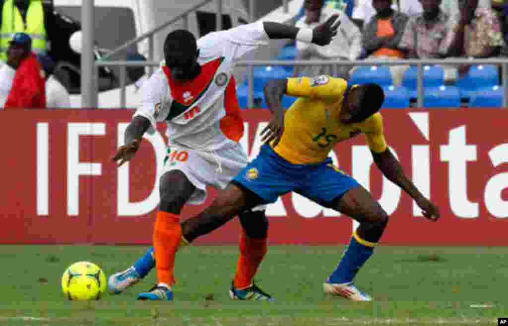 Gabon's Biyong Poko fights for the ball with Niger's Boubacar Djibo during their African Nations Cup Group C soccer match at Stade De L'Amitie Stadium in Libreville