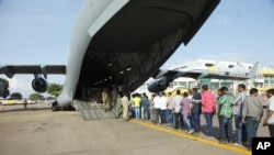 Indian nationals board an Indian Air Force plane July 14, 2016, as they leave Entebbe, Uganda, to go back home after arriving from Juba, South Sudan. India and other nations continue to evacuate citizens from South Sudan, where fears of a return to civil war persist. 