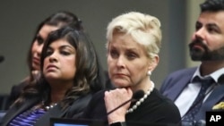 FILE - Cindy McCain (C), co-chair of the McCain Institute's Human Trafficking Advisory Council, and trafficking survivor Rani Hong (2nd-L), listen after addressing the human rights conference during the United Nations General Assembly at U.N. headquarters, Sept. 24, 2018.