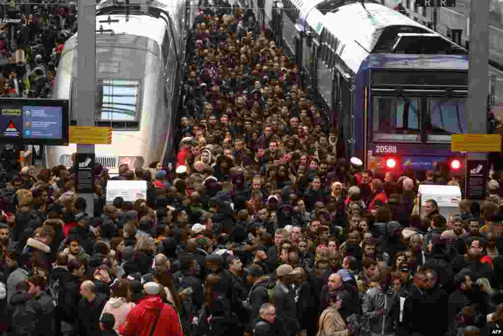 Commuters stand on a crowded platform of the Gare de Lyon railway station in Paris, on the first day of a two-day strike. Staff at state rail operator SNCF walked off the job from 7.00 pm (1700 GMT) on April 2, the first in a series of walkouts affecting everything from energy to garbage collection.