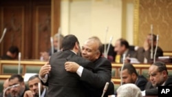 Saad el-Katatni embraces another member of parliament after being nominated by the Freedom and Justice Party for the post of the Parliament speaker, 23 Jan. 2012